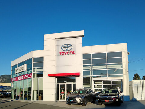 Penticton, Canada - June 22, 2026: The exterior of a Toyota dealership in Penticton Canada shows several vehicles for sale. The brand logo is visible on the building.