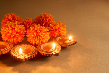Obraz na płótnie Canvas Diwali celebration with lit diyas and marigold flowers