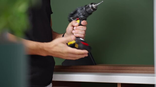 Man putting drill bit into cordless drill before work