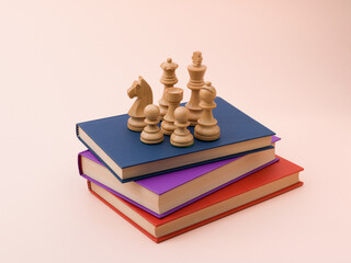 Wooden Chess Pieces on Stack of Colorful Books for Learning Concept © stokkete