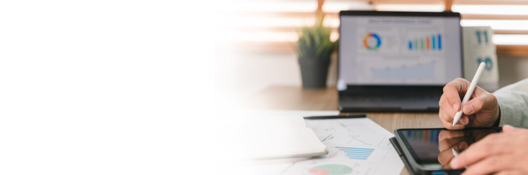 Business background and banner showing financial data analysis on tablet with stylus pen in modern office. Corporate planning workspace concept featuring copy space for commercial design