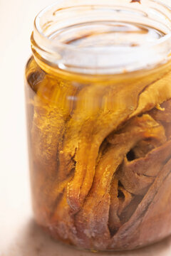 bottle of salted anchovies in olive oil