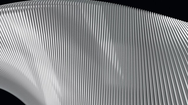 Close-up of silver ribbed metal surface arching over black edges