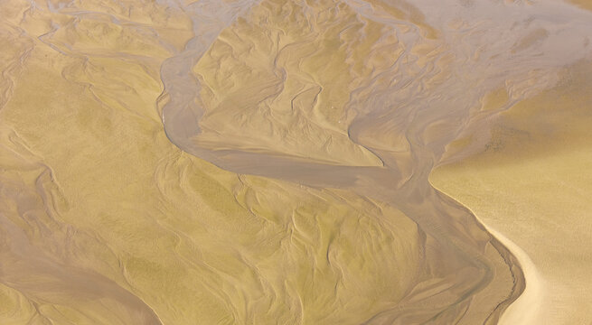 Aerial view showing abstract sand and water patterns