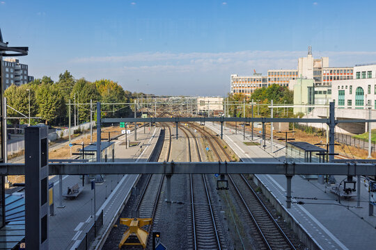 Heerlen, Netherlands: Elevated overview of the train station tracks, platforms, and overhead wires in Heerlen city center.