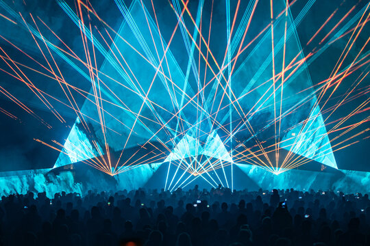 Impressive geometrical red and cyan laser network projected over spectators at Light Festival.