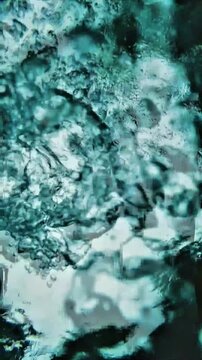 Close-up view of clear rippling water surface with rising air bubbles creating fresh organic fluid texture in cool blue tones