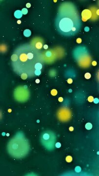 Soft round bokeh lights in calming teal yellow and blue floating softly against deep emerald green background