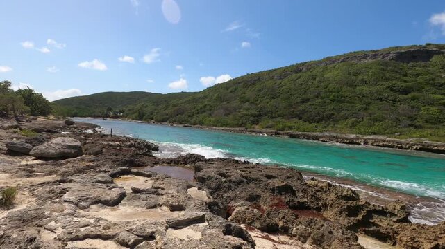 Porte d'Enfer coastal cliffs landscape in Grande-Terre, Guadeloupe, Lesser Antilles, Caribbean. Turquoise ocean water flowing along the rocky coast of Hell's Gate, Grande-Terre, Guadeloupe, Lesser Ant