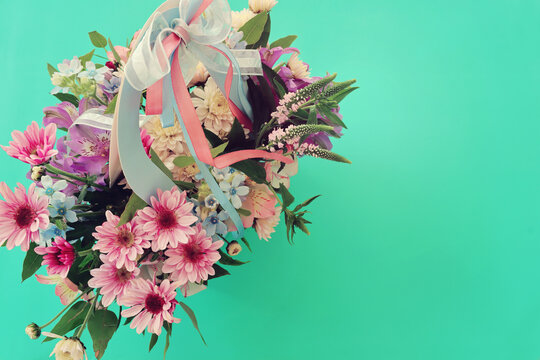 Top view image of romantic and delicate flowers on pastel background