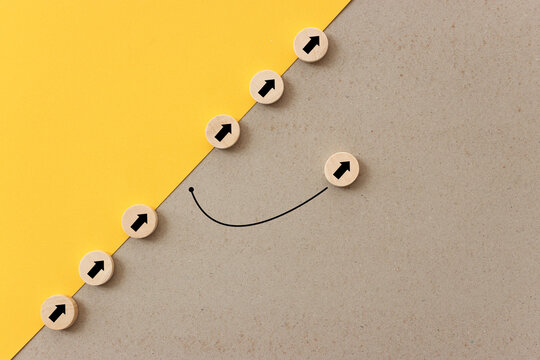 Arrows on wooden blocks, idea of thinking differently, setting goals and thinking about solution