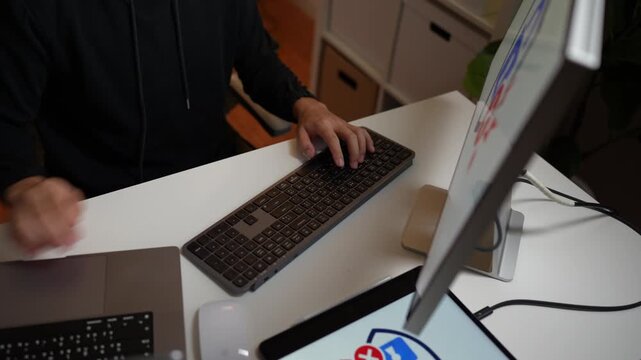 Cybersecurity threat displayed on laptop and computer screens with red warning symbols and a hacked alert, representing a cyberattack and data breach.