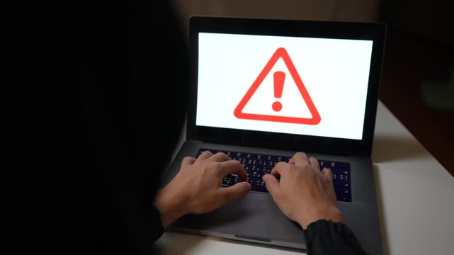 Cybersecurity threat displayed on laptop and computer screens with red warning symbols and a hacked alert, representing a cyberattack and data breach.