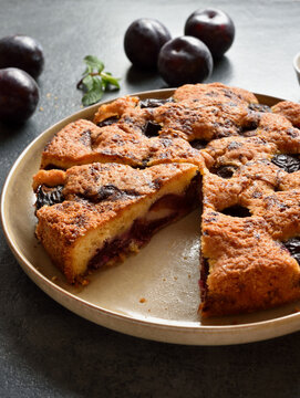 Warm autumn plum pie on plate
