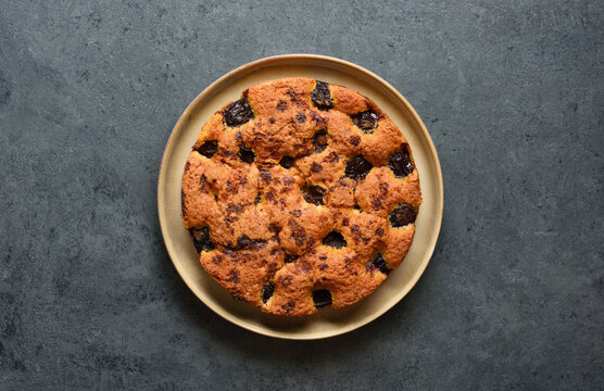 Warm autumn plum pie on plate