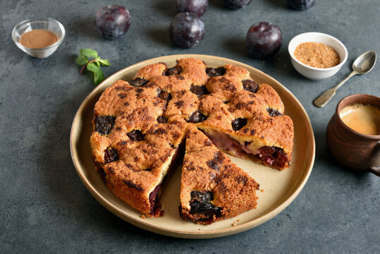 Warm autumn plum pie on plate