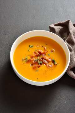 Creamy pumpkin soup with roasted bacon and thyme