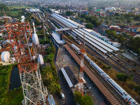 Aerial View of Telecommunication Tower with Radio Masts and Equipment Near a Railway Station in the Morning in Purwokerto, Central Java, Indonesia.