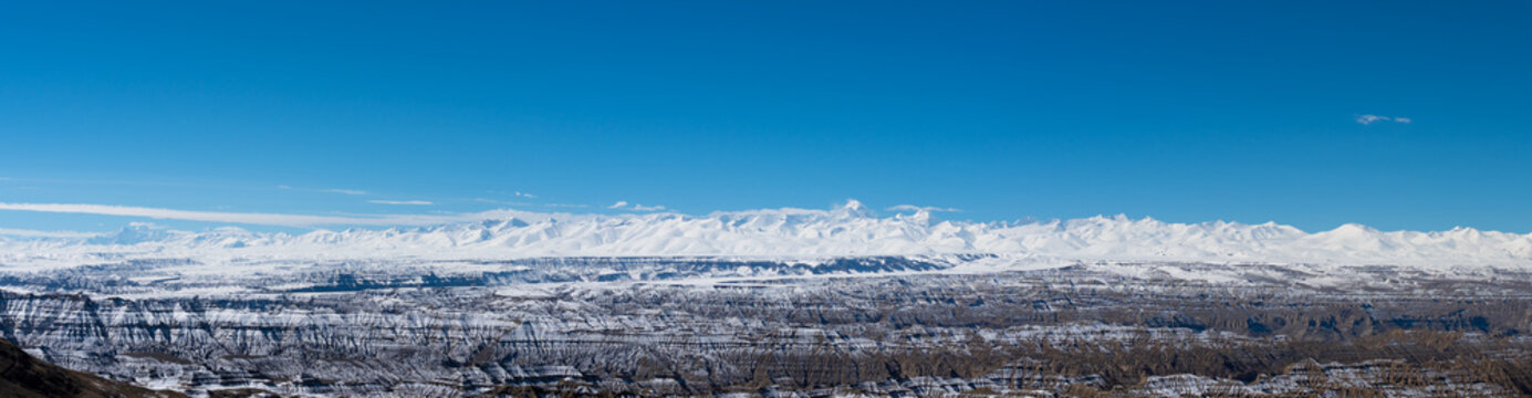 Wide panorama of snowy Zanda badlands and Himalayan peaks
