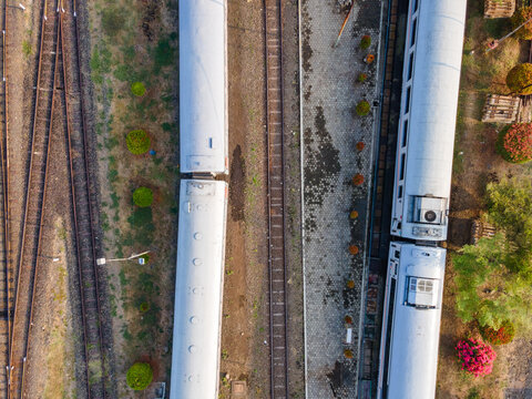 Aerial Top-Down View of Passenger Train Carriages Lined Up at Purwokerto Railway Station in the Morning, Central Java, Indonesia.