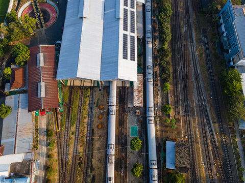 Aerial Top-Down View of Passenger Train Carriages Lined Up at Purwokerto Railway Station in the Morning, Central Java, Indonesia.