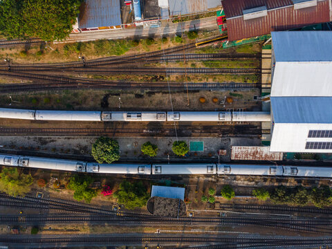 Aerial Top-Down View of Passenger Train Carriages Lined Up at Purwokerto Railway Station in the Morning, Central Java, Indonesia.