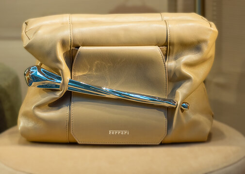 Beige Ferrari Pillow Bag, a high-fashion accessory featuring a metal bar that acts as a fastening and the brand&rsquo;s logo in the centre of the flap.  Milan &ndash; Italy, 1 October 2026