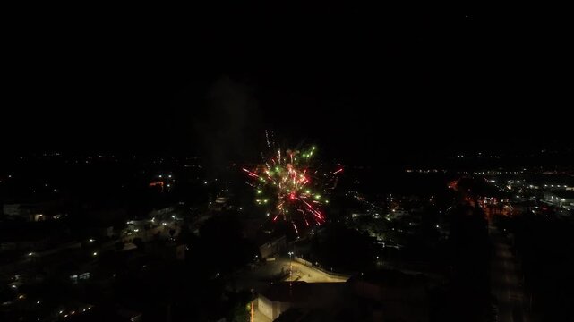 Fireworks exploding in the night sky over a city skyline