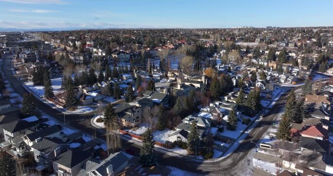 Aerial view of a residential neighborhood blanketed in snow on a winter day in Calgary, Alberta, Canada.