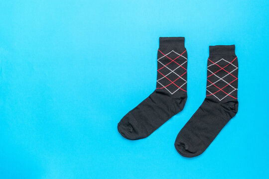 Pair of Argyle Pattern Socks on Vibrant Blue Background