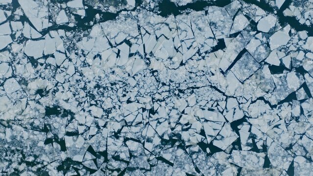 Aerial View of Small Ice Floes Drifting on a Frozen River
