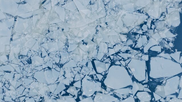 Aerial View of Small Ice Floes Drifting on a Frozen River