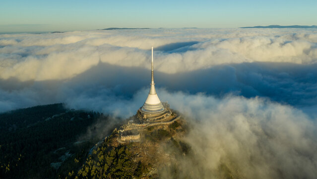 Aerial View of Jested Tower Above Rolling Clouds
