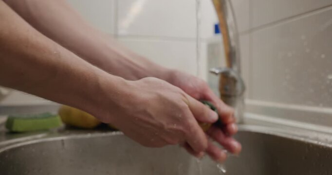 Close-up male hands wash rinse potatoes. 4K 10-bit