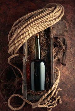 An antique bottle of hard liquor in a vintage wooden box.