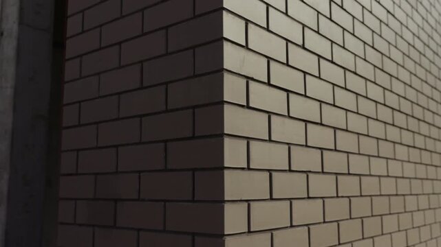 Close up of brick building corner with contrasting sunlight and shadow