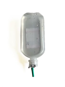 Medical IV saline infusion bottle filled with liquid solution for hospital treatment isolated on white background.