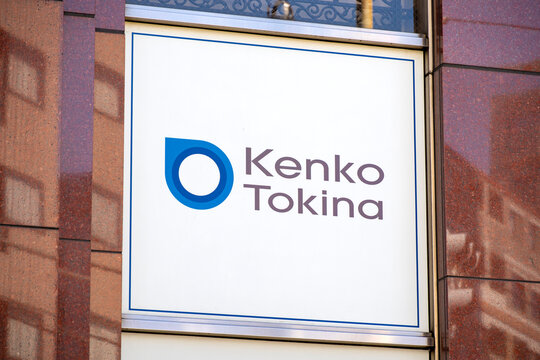 NAKANO-KU, TOKYO, JAPAN - OCTOBER 1, 2026: Wall-mounted blue corporate logo signboard on the building facade of Kenko Tokina headquarters in Nakano-ku, Tokyo.