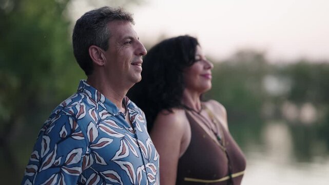 Happy mature couple appreciating the beauty of nature. Serene moment of a husband and wife standing outdoors enjoying a peaceful scenery