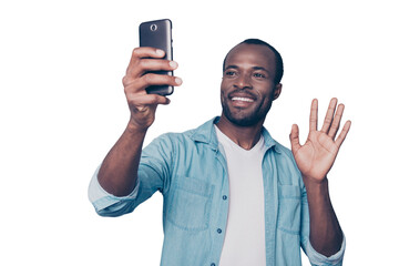 Portrait of cheerful, positive, professional man making selfie on his gadget, electronic, device, holding smart phone in hand, having video-call, sending hello to friend, isolated on grey background © deagreez