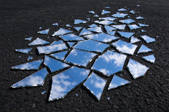 Broken mirror shards reflecting the blue sky