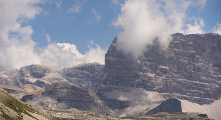 Fototapeta premium Mountain landscape panorama Tre Cime Mount against a blue summer background. 