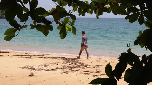 Man walking over a pristine beach on Pr&iacute;ncipe island, S&atilde;o Tom&eacute; und Pr&iacute;ncipe