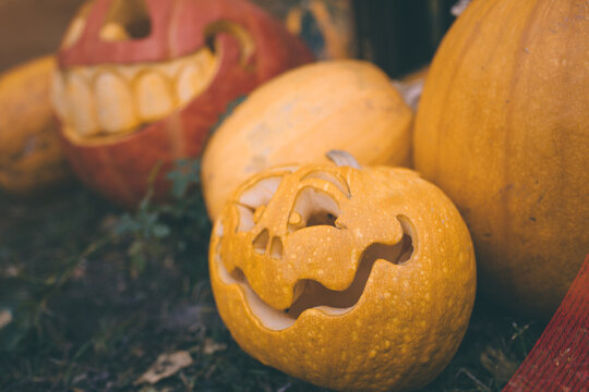 Ghost pumpkins on Halloween. ead Jack on an autumn background. Holiday outdoor decorations