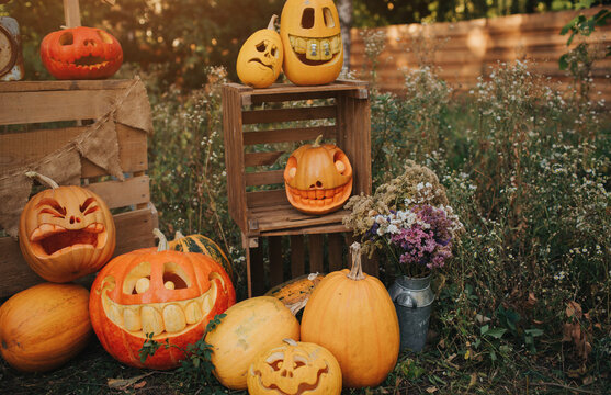Ghost pumpkins on Halloween. ead Jack on an autumn background. Holiday outdoor decorations