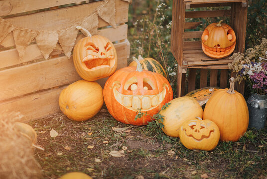 Ghost pumpkins on Halloween. ead Jack on an autumn background. Holiday outdoor decorations