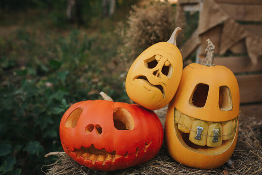 Ghost pumpkins on Halloween. ead Jack on an autumn background. Holiday outdoor decorations
