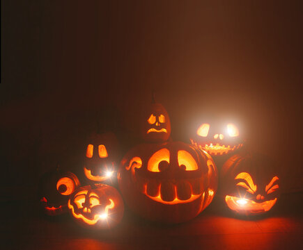 Ghost pumpkins on Halloween. ead Jack on Dark background. Holiday indoor decorations.
