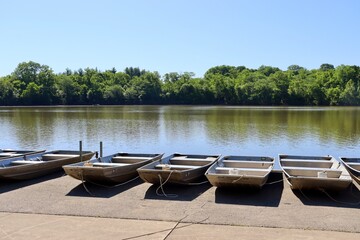 A row of boats at the lake on a sunny day. © Al