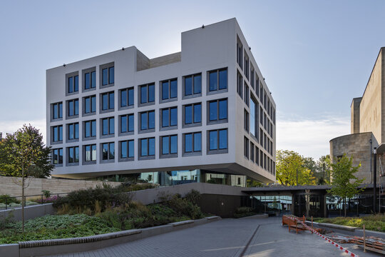 Heerlen, Netherlands - October 04, 2026: Wide perspective view of modern glass and concrete Gemeentehuis City Hall architecture with landscaped garden.